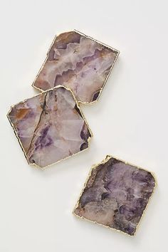 three pieces of purple stone sitting on top of each other