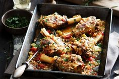 a pan filled with meat and vegetables covered in sauce