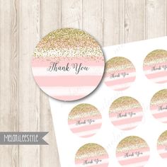 pink and gold glitter stickers with thank you written on the top, in front of a