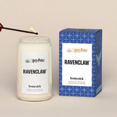 a harry potter candle next to a blue box with the words ravenclaw on it