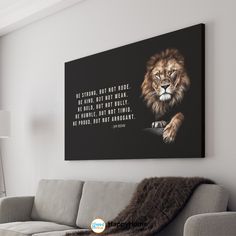 a living room with a couch and a painting on the wall that says be strong, but not rude