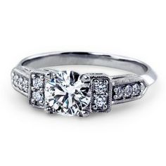 a white gold engagement ring with diamonds on the sides and an old - fashioned style band