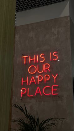 a neon sign that says this is our happy place