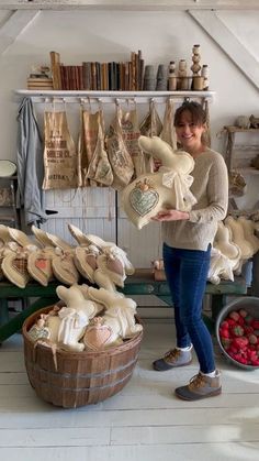 a woman standing in front of baskets full of strawberries and other items on display