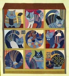 a quilted wall hanging with many cats on it's sides and in the center