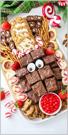 a platter filled with cookies, candy bars and other treats for the holiday season