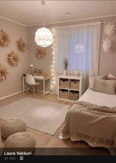 a bedroom decorated in neutrals and whites with flowers on the wall