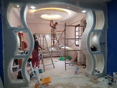 two men are working on the inside of a house that's being built in progress