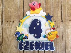 a birthday cake with the number four on it and some cartoon characters in front of it