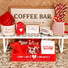 a coffee bar with red and white boxes, candy bars, cups, and napkins