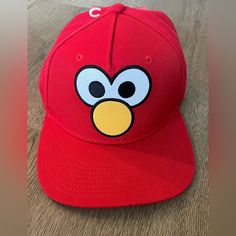 a red hat with an angry bird face on it