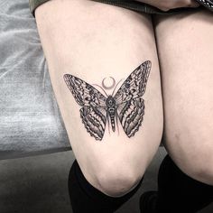 a woman's thigh with a butterfly tattoo on it