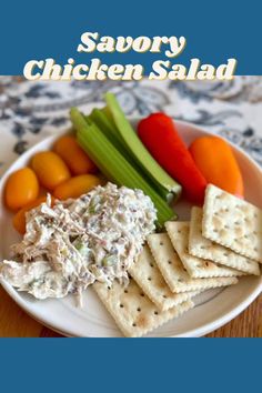 a white plate topped with crackers and veggies