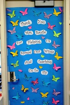 a blue door decorated with butterflies and words