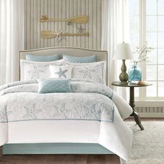 a bed with blue and white comforters in a bedroom