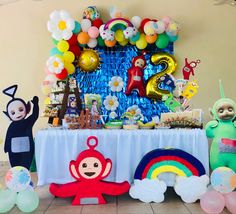 a table with balloons, stuffed animals and decorations for a children's birthday party