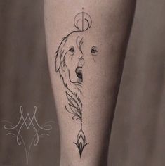 a woman's leg with a tattoo on it and a wolf head in the middle