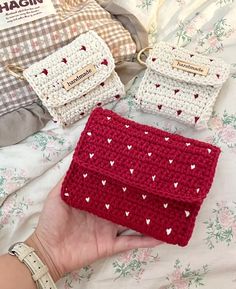 three crocheted purses sitting on top of a bed next to each other