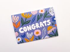 congratulations card with colorful flowers and plants on purple paper that reads, congrats