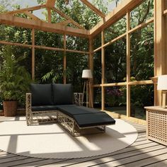 an outdoor living area with couches, tables and lamps in the sunrooms