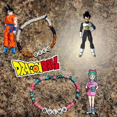 two dragon ball bracelets and one beaded necklace are on the ground next to each other