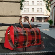 Beautiful plaid printed travel bag. Made with high-grade waterproof fabric, it's a highly durable means of transferring your essentials wherever you go. With multiple compartments, a resilient carrying handle, and an adjustable shoulder strap, it's the perfect companion for all your adventures.  .: 100% high-grade PU leather .: One size: 20" × 12'' × 9" (50.8cm × 30.5cm × 23cm ) .: Brown PU leather handles and an adjustable shoulder strap .: Polyester lining .: Gold-colored zipper  .: All-over printImages by [Zlatko Guzmic, Zlatko Guzmic, Zlatko Guzmic, Zlatko Guzmic / Shutterstock]Images by [vector punch, vector punch, vector punch, vector punch / Shutterstock]Images by [vector punch, vector punch, vector punch, vector punch / Shutterstock]Images by [vector punch, vector punch, vector pun Red Waterproof Travel Bag, Red Duffle Bag With Luggage Sleeve, Everyday Red Duffle Bag With Luggage Sleeve, Functional Red Duffle Bag For Travel, Large Capacity Plaid Travel Bags, Functional Red Travel Bag With Luggage Sleeve, Large Capacity Red Bag For Overnight Trips, Red Duffle Bag With Luggage Sleeve For Overnight Trips, Red Duffle Bag With Large Capacity For Daily Use