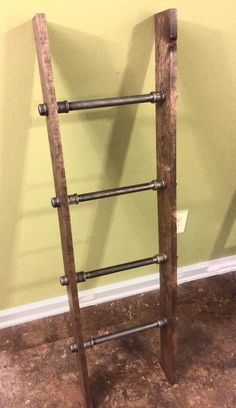 an old wooden ladder leaning against the wall in a room with no one around it