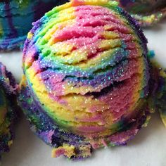 there is a ball of colored cake with sprinkles on it