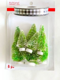 small green trees in a clear plastic package