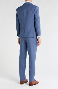 Bring understated elegance to the table in this three-piece suit crafted from rich fabric in a classic single-breasted silhouette. Jacket has notched lapels; chest welt pocket; front flap pockets Vest has front button closure; V-neck Pants have zip fly with button closure; front slant pockets; back button-welt pockets Jacket and vest are lined; trousers are lined to the knee 65% polyester, 35% viscose Dry clean Imported Each suit has a 6” drop, meaning that a size 38R jacket is paired with size Tailored Blue Suiting Fabric Sets, Blue Notch Lapel Suiting Fabric Sets, Classic Tailored Blue Sets, Classic Slim Fit Blue Sets, Elegant Slim Fit Solid Color Set, Blue Formal Sets With Welt Pockets, Formal Blue Suiting Fabric Sets, Fitted Elastane Suits With Notch Lapel, Elegant Elastane Suits For Formal Occasions