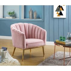 a pink chair sitting on top of a hard wood floor next to a coffee table