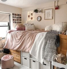 a bedroom with white drawers and pink blankets on top of the bedspread is shown