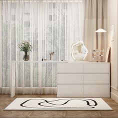 a white dresser sitting in front of a window next to a tall curtained window