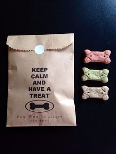 two dog treats and a paper bag with the words keep calm and have a treat on it