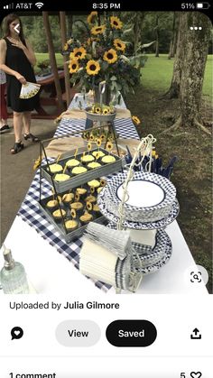 a table with sunflowers and cupcakes is shown on an iphone screen