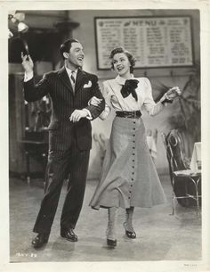 an old black and white photo of two people dancing