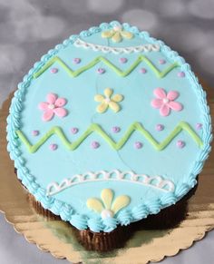 a decorated blue cake sitting on top of a table