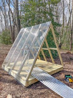 a small wooden structure in the woods