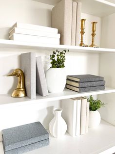 white shelves with books and vases on them