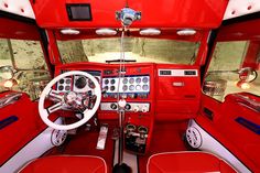 the interior of a car with red leather seats and white dash board, steering wheel and dashboard