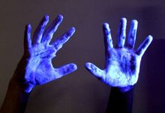 two hands with blue light painted on them