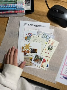 a person is looking at papers on a desk with a computer mouse and other items