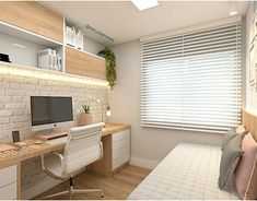 a computer desk sitting in front of a window next to a white brick wall and wooden shelves