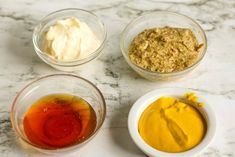 three bowls filled with different types of food on top of a marble countertop next to each other