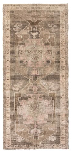 an antique rug with many different colors and patterns on the carpet, including pinks, browns