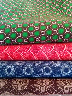 four different fabrics stacked on top of each other in various colors and patterns, all showing the same pattern