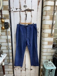 Antique vintage French Le Pigeon Voyageur blue cotton workwear chores trousers size M. 100% Cotton. Maker's label inside. Top button, button fly, belt loops, ticket pocket, pockets, button down back pocket. Size:  Waist: 36 inches; rise: 14 inches; Length: 41.5 inches; leg inseam: 28.5 inches;  Weight: allow 1 kg once packed. Condition commensurate with age and use - leg seam coming apart a little on one leg near cuff but easily fixed with a stitch and one belt loop is frayed but overall fine. P Utility Cotton Jeans With Buttons, Blue Cotton Jeans With Buttons, Vintage Workwear Pants With Buttons, Vintage Pants With Buttons For Workwear, Vintage Blue Cotton Jeans, Vintage Cotton Bottoms With Buttons, Vintage Cotton Jeans With Pockets, Vintage Washed Blue Bottoms With Pockets, Retro Style Denim Blue Cotton Pants