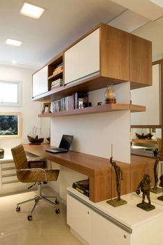 a desk with a laptop and some books on it