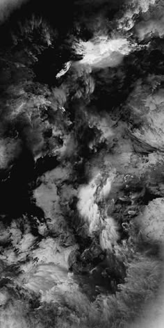 black and white photograph of clouds in the sky from space, looking down on earth