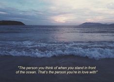 an ocean with waves crashing on the shore and a quote written above it that reads, the person you think of when you stand in front of the ocean